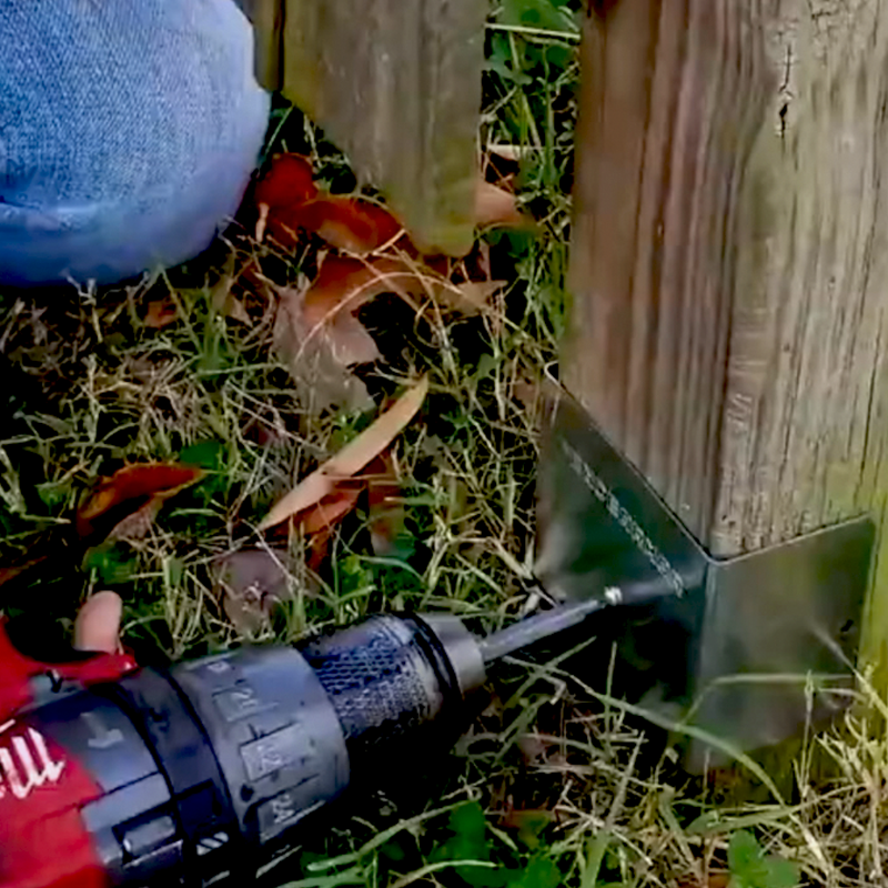 Close up of person using drill to install Fence Armor